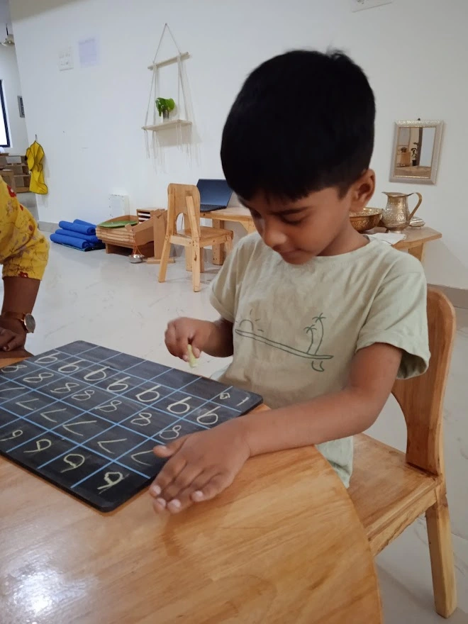 Kid learning to write numbers