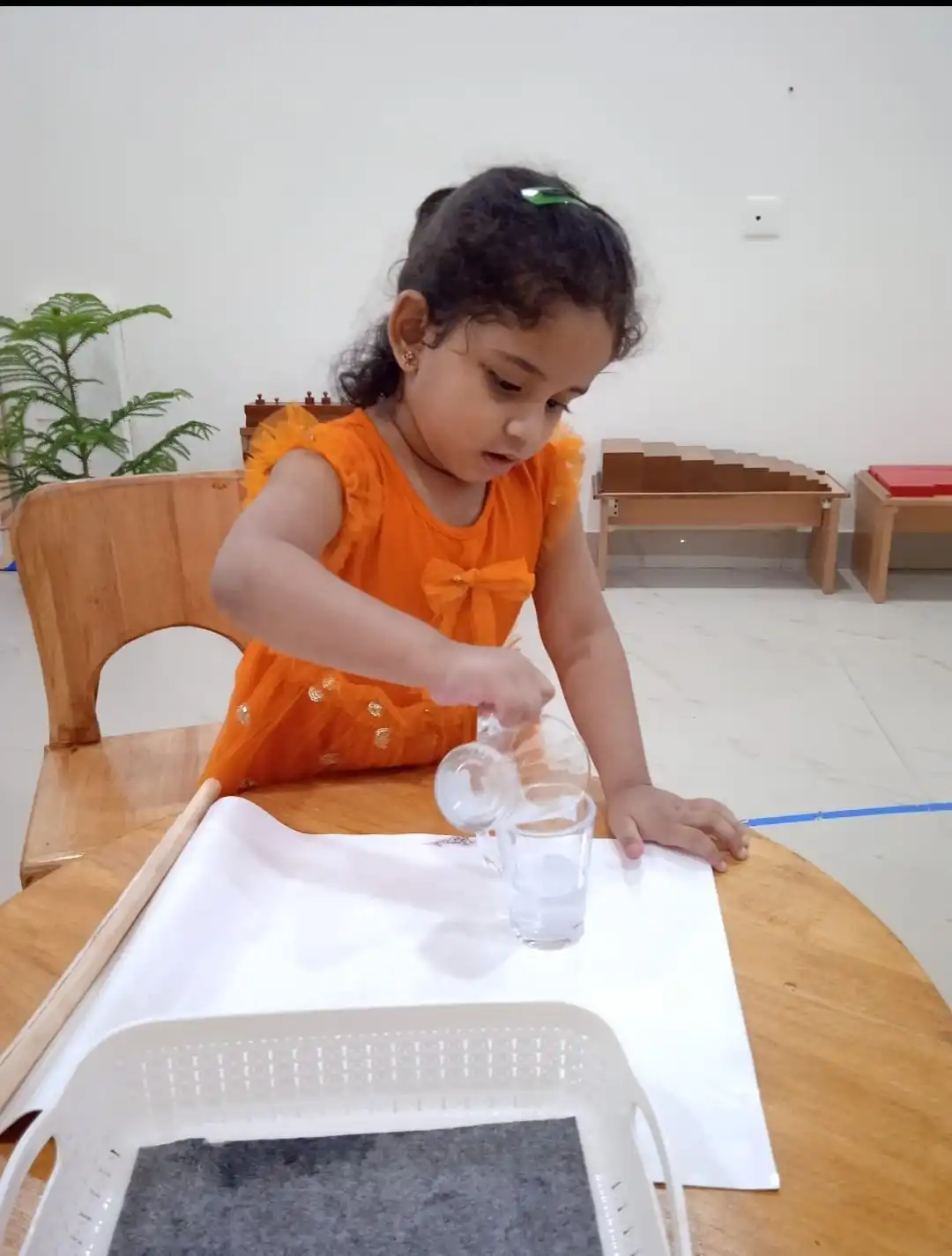 Child learning to roll dough